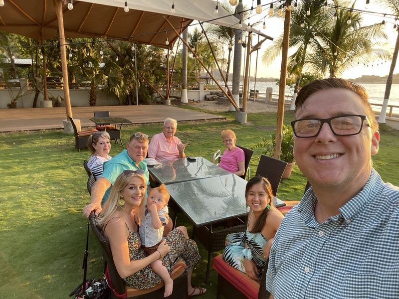 My family and I at dinner under palms at sunset