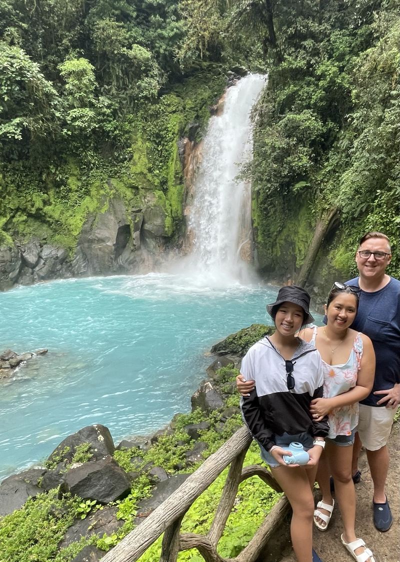 My family and I at a turquoise waterfall in Costa Rica